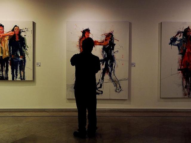 A visitor watches "Intersubjectivities", part of the exhibition by Costa Rican artists held at the National Gallery in San Jose on March 7, 2012. The exhibition is part of the "Museums and Galleries Route" during the XIII International Arts Festival to be held in San Jose from 1 to 25 March. (AFP Photo)