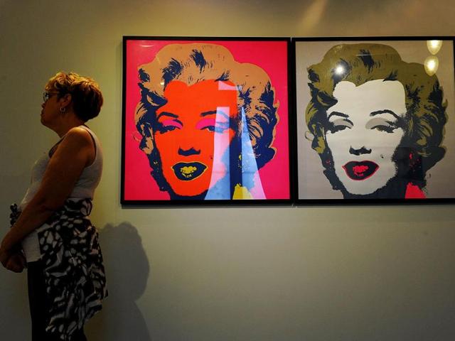 A visitor stands beside Andy Warhol's "Marlyn" at the National Gallery in San Jose on March 7, 2012. The exhibition is part of the "Museums and Galleries Route" during the XIII International Arts Festival to be held in San Jose from 1 to 25 March. (AFP Photo)