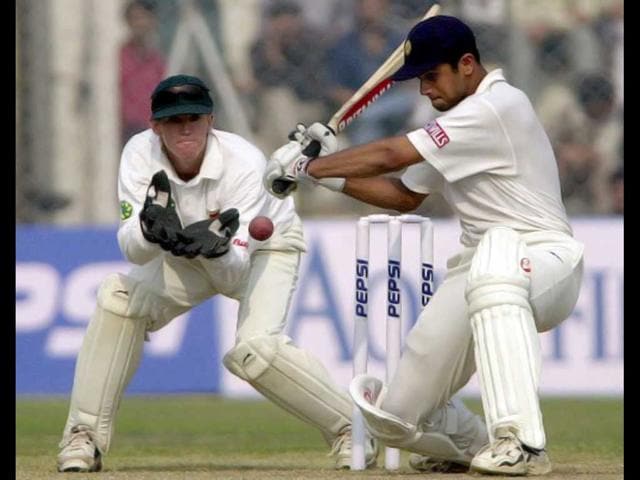 200* - Rahul Dravid (R) hits a delivery from Zimbabwe bowler Brian Murphy (not in the picture) as Zimbabwe wicketkeeper Andy Flower looks on during the Test match between India and Zimbabwe on 21 November 2000 in New Delhi. Dravid remained unbeaten on 200 runs. AFP PHOTO/Arko Datta