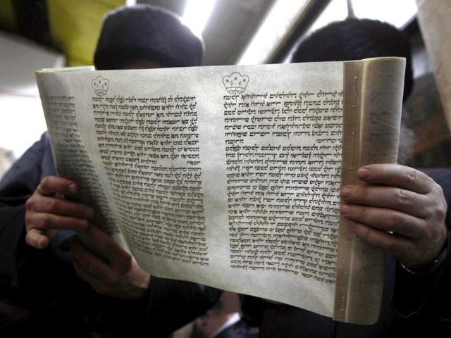 Ultra-Orthodox Jews read The Book of Esther during celebrations for the Jewish holiday of Purim at a synagogue in Bnei Brak. Reuters/Ronen Zvulun.