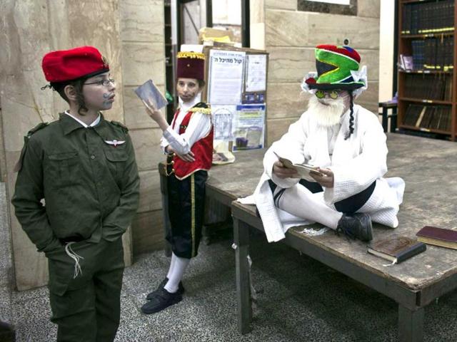 Ultra-Orthodox Jewish boys dressed in a special costume for Purim are seen while celebrating the Jewish holiday of Purim at a synagogue in Bnei Brak. Reuters/Nir Elias.