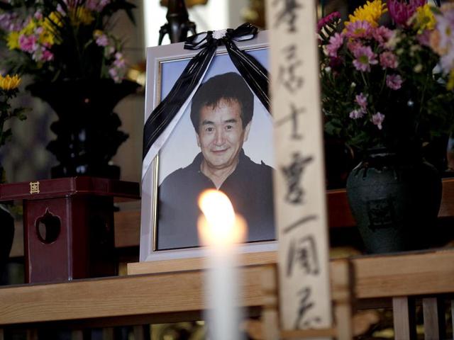 A portrait of a person who was killed during last year's earthquake and tsunami is seen at a temple during a ceremony in Ofunato, Iwate Prefecture, ahead of the one-year anniversary of the disasters. (Reuters/Carlos Barria)