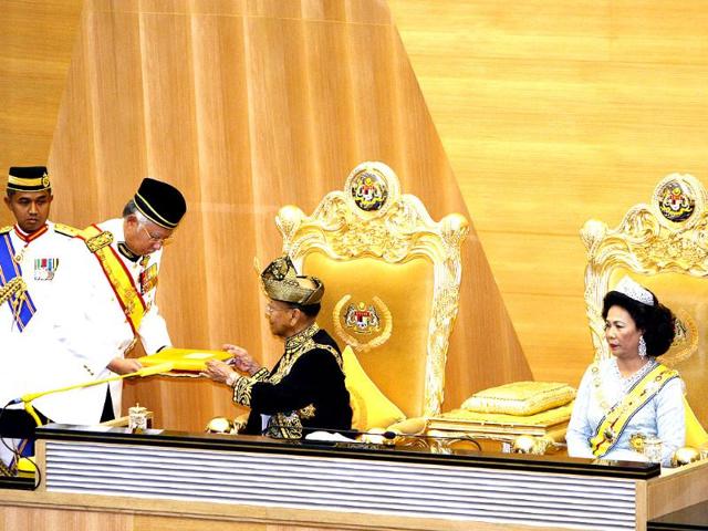 Malaysian Prime Minister Najib Razak, second from left, passes the opening speech to King Sultan Abdul Halim Mu'adzam Shah as Queen Haminah Hamidun, right, looks on during the opening of a parliament session at the Parliament House in Kuala Lumpur, Malaysia. AP Photo/Lai Seng Sin