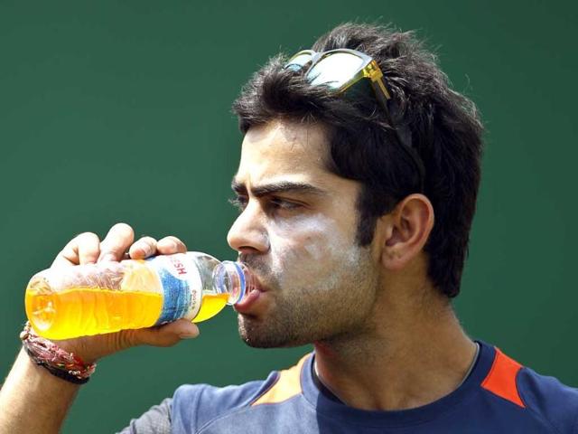 Virat Kohli sips a drink after attending a training session in Dhaka, Bangladesh. AP/Aijaz Rahi