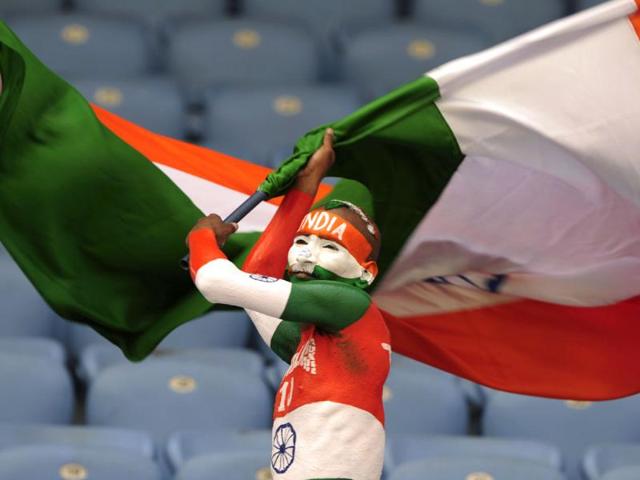 An Indian supporter waves the national flag prior to the one day international Asia Cup cricket match against Sri Lanka at the Sher-e-Bangla National Cricket Stadium in Dhaka. AFP/Munir uz Zaman