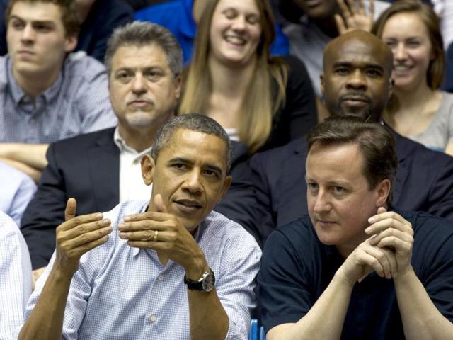 US President Barack Obama and Britain Prime Minister David Cameron attend the Mississippi Valley State versus Western Kentucky first round NCAA tournament basketball game in Dayton, Ohio. AP Photo/Carolyn Kaster