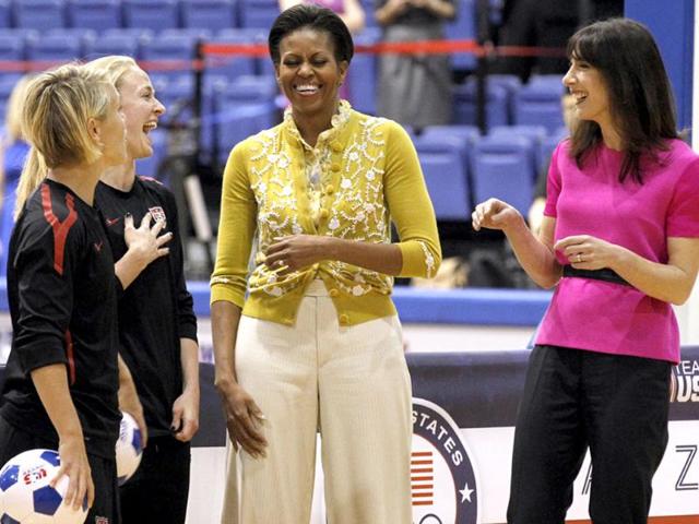 US First lady Michelle Obama and Samantha Cameron, wife of British Primer Minister David Cameron, talk with United States Women's National Soccer Team midfielder Lori Ann Lindsey (L) and defender Becky Sauerbrunn as they join with students participating in a mini-Olympics competition in celebration of the 2012 London Summer Olympics and Mrs. Obama’s Let’s Move! initiative in Washington. AP Photo/Haraz N. Ghanbari