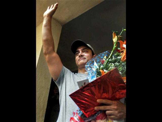 Bollywood actor Aamir Khan waves to fans as he celebrates his 47th birthday at his residence in Mumbai on Wednesday. (PTI)