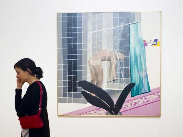 A woman walks past the painting "Man in Shower in Beverly Hills" by David Hockney in the Pacific Standard Time exhibition at the Martin-Gropius-Bau exhibition hall in Berlin.(Reuters)