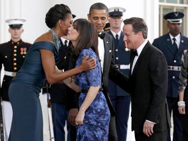 US President Barack Obama and first lady Michelle Obama greet British Prime Minister David Cameron and his wife Samantha after arriving at the White House for a State Dinner held in their honor. Reuters/Kevin Lamarque
