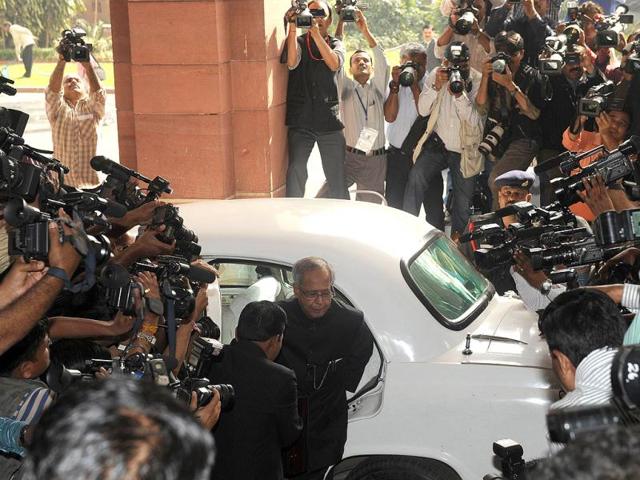 Finance minister Pranab Mukherjee arrives at parliament surrounded by the media prior to presenting the national budget in New Delhi. Government was due to deliver its budget as an acrimonious split in its ranks over hiking rail fares highlighted the increasingly dysfunctional nature of the ruling coalition. The Congress-led administration, already battered by a string of graft scandals, is under financial market pressure to cut public spending and rein in a ballooning deficit at the same time as spurring slowing growth. AFP PHOTO/ Raveendran