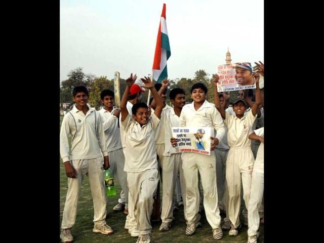 Cricket lovers celebrate Sachin Tendulkar acheiving a landmark 100 international centuries during the Asia Cup One-dayer against Bangladesh, in Lucknow on Friday. Agencies