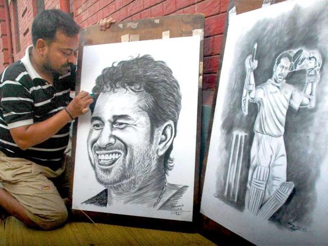 Painter Ramjan Ali gives finishing touch to a painting of cricketer Sachin Tendulkar to greet him for his 100th ton, in Kolkata. PTI Photo