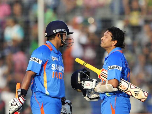 Suresh Raina speaks to Sachin Tendulkar after Sachin scores his 100th century during the ODI Asia Cup cricket match between India and Bangladesh. AFP/Munir uz Zaman