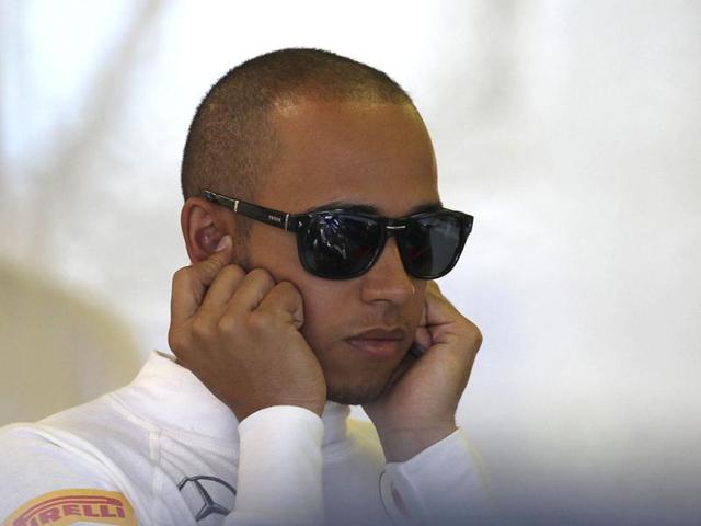 McLaren driver Lewis Hamilton of Britain blocks his ears in his garage during the third practice session for Sunday's Australian Formula One Grand Prix at the Albert Park in Melbourne, Australia. AP/Rob Griffith