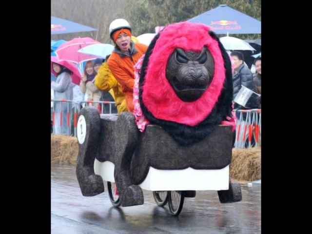 A performer races with his peddle powered box cart during the 2nd Red Bull Box Cart race at the Kasai Rinkai Park in Tokyo. Some 60 race teams attended the race. AFP PHOTO / KAZUHIRO NOGI