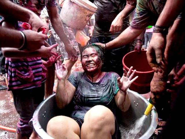 A tourist celebrates Holi at a temple in Kuala Lumpur. AFP Photo/Mohd Rasfan