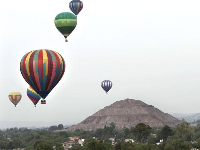 Hot air balloons float near the Pyramid of the Sun during a hot air balloon festival in Teotihuacan, just north of Mexico City. AP Photo/Marco Ugarte