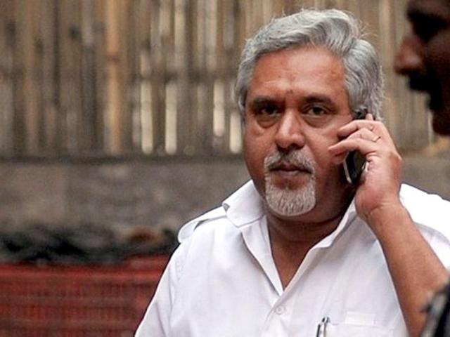 Chairman-and-CEO-of-Kingfisher-Airlines-Vijay-Mallya-talks-on-his-cellphone-during-a-meeting-with-pilots-in-New-Delhi-AFP-Photo-Manan-Vatsyayana