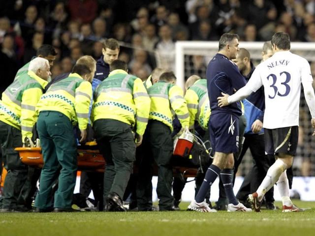 Tottenham Hotspur's Ryan Nelsen (R) puts his arm around Bolton Wanderers' manager Owen Coyle after Bolton Wanderers' Fabrice Muamba collapsed. The match was abandoned after Muamba collapsed near the centre circle. Reuters/Suzanne Plunkett