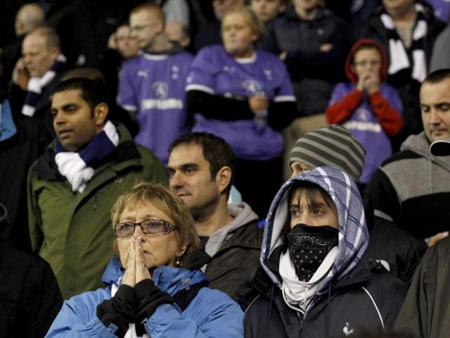 Fans wait to hear news after Bolton Wanderers' Fabrice Muamba was carried off the field during their FA Cup quarter-final match against Tottenham Hotspur at White Hart Lane. Reuters/Suzanne Plunkett