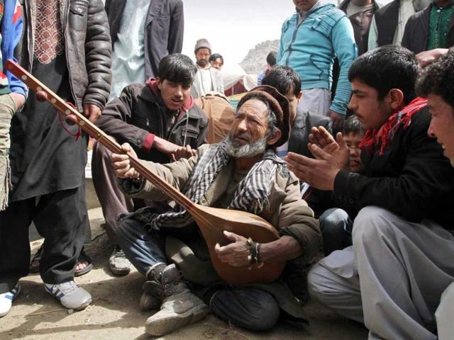 An Afghan musician plays an instrument called a dombura at a celebration of the Persian New Year Nowruz in Kabul. AP Photo/Musadeq Sadeq