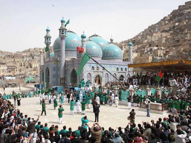 Afghan men raise the holy mace during a celebration of the Persian New Year Nowruz at the Kart-e-Sakhi shrine in Kabul. AP Photo/Musadeq Sadeq