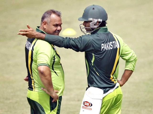 Pakistan's Mohammad Hafeez, right, talks to team coach Dav Whatmore during a training session in Dhaka, Bangladesh. AP Photo/Aijaz Rahi.
