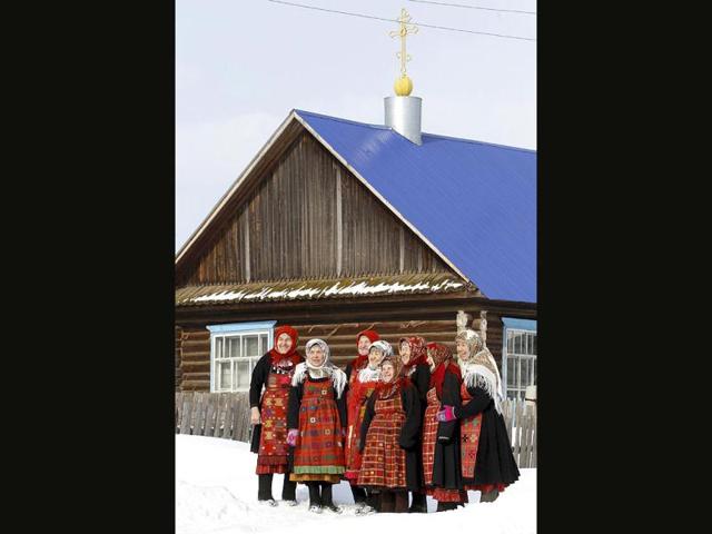 The singing group "Buranovskiye Babushki" pose for a picture outside a prayer house in Buranovo in the central Russian region of Udmurtia. A group of ladies ranging in age from 43 to 86 who sing traditional songs and pop classics in their own language have been voted by popular demand to represent Russia in the forthcoming Eurovision song contest. (L-R) Granya Baisarova, 62, Ekaterina Shklyaeva, 74, Zoya Dorodova, 72, Valentina Pyatchenko, 74, Natalia Pugachova, 76, Galina Konyeva, 74, Alevtina Byagisheva, 54, Olga Tuktaryova , 43. REUTERS/Sergei Karpukhin