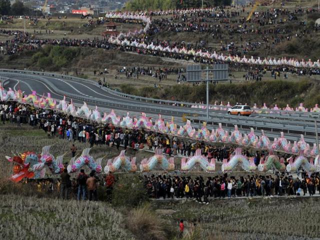 Villagers perform the annual "dragon march" to celebrate the Lantern Festival in Gutian township, Fujian province on February 6, 2012. The marching dragon, made of paper and bamboo and connected by wood planks, set the new Guinness World Records of the longest parade float with 791.5 meters. Reuters
