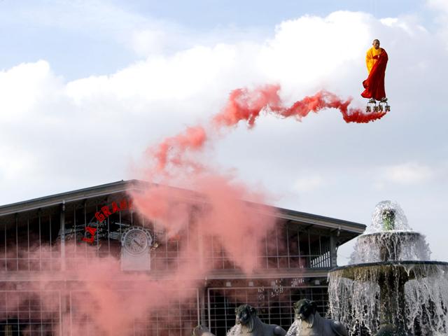 Suspended by wires, Chinese artist Li Wei performs in the sky over the Fontaine of Lyons at La Villette in Paris. (AP Photo/Francois Mori)