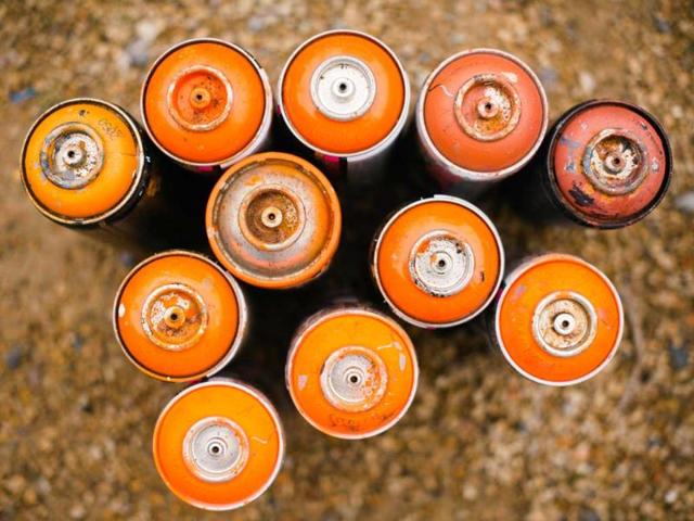 Spray cans are gathered together before street artists begin their work on a section of wall near Westbourne Park in north London. AFP/Leon Neal