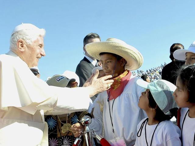 Pope Benedict XVI caresses a young Mexican boy as he arrives in Leon. The Pope arrived for a three-day visit in Mexico. (Reuters/Osservatore Romano)