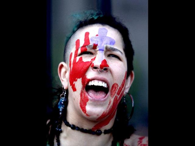 A demonstrator chants slogans during a protest march against Pope Benedict XVI's papal visit to Mexico, in Mexico City. (AP Photo/Marco Ugarte)