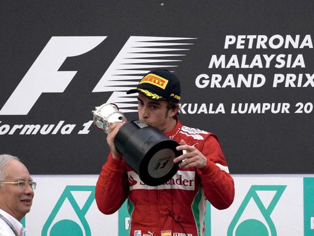 Ferrari-driver-Fernando-Alonso-C-of-Spain-kisses-his-winning-trophy-after-receiving-it-from-Malaysian-prime-minister-Najib-Razak-2nd-L-during-the-ceremony-of-Formula-One-s-Malaysia-Grand-Prix-at-the-Sepang-International-Circuit-AFP-Photo-Saeed-Khan Ferrari-driver-Fernando-Alonso-C-of-Spain-kisses-his-winning-trophy-after-receiving-it-from-Malaysian-prime-minister-Najib-Razak-2nd-L-during-the-ceremony-of-Formula-One-s-Malaysia-Grand-Prix-at-the-Sepang-International-Circuit-AFP-Photo-Saeed-Khan