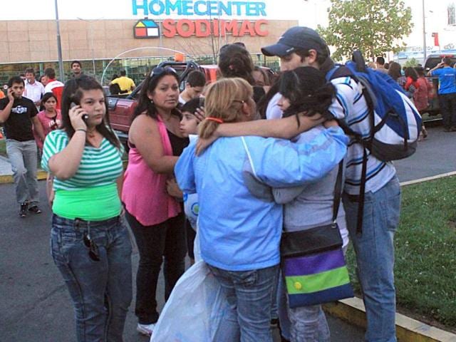 People gather outside a supermarket after an earthquake was felt in Talca, Chile. A magnitude-7.2 earthquake has struck just off the coast of central Chile, prompting an emergency evacuation order for people living near the ocean in case it spawns a tsunami. (AP Photo/Fabian Suazo)