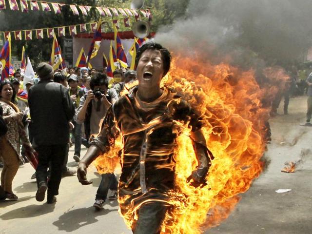 A Tibetan man screams as he runs engulfed in flames after self-immolating at a protest in New Delhi. AP Photo/Manish Swarup