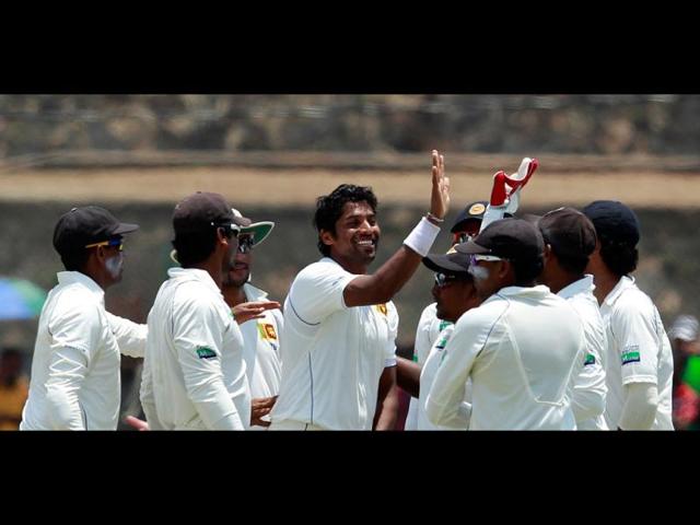 Sri Lanka's Chanaka Welegedara (C) celebrates with teammates after taking the wicket of England's Kevin Pietersen during the second day of the first test cricket match in Galle. REUTERS/Dinuka Liyanawatte
