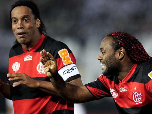 Brazil's Flamengo player Vagner Silva, right, celebrates after scoring against Paraguay's Olimpia as teammate Ronaldinho looks on during a Copa Libertadores soccer game in Asuncion, Paraguay. AP/Jorge Saenz