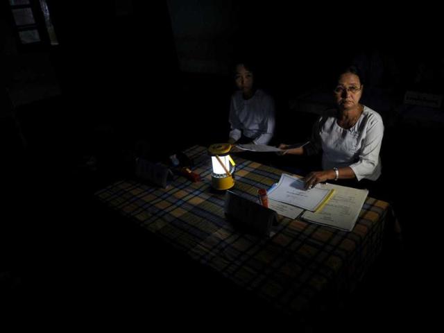 Election officials get ready before the opening of the polling station in Kawhmu. AFP/Christophe Archambault