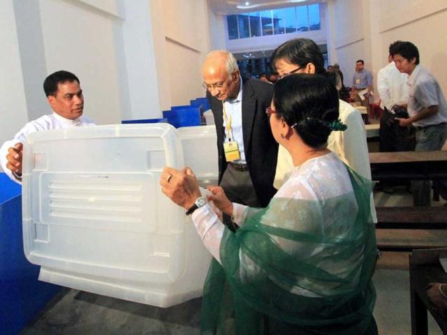 An official election observer from the Indian embassy checks a polling station in Yangon. AFP/Ye Aung Thu