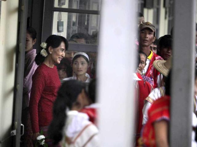 Myanmar's pro-democracy leader Aung San Suu Kyi leaves a polling station in the village of Wah Thin Kha. AP/Altaf Qadri