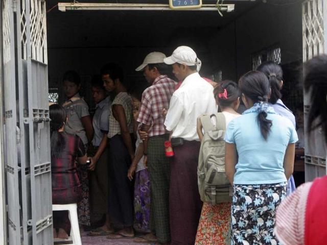 Myanmar voters line up to cast their vote for by-election at a polling station in Dagon Seikkan Township, eastern part of Yangon. AP/Khin Maung Win
