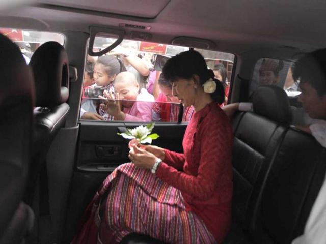 Myanmar's pro-democracy leader Aung San Suu Kyi leaves a polling station in her car in the village of Wah Thin Kha, Myanmar. AP/Altaf Qadri