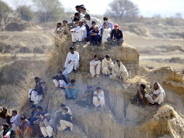 Spectators watch a dog fighting match in Tangdhe Sayedan, a village in the breadbasket province of Punjab, 110 kilometres east of Islamabad. AFP/Aamir Qureshi