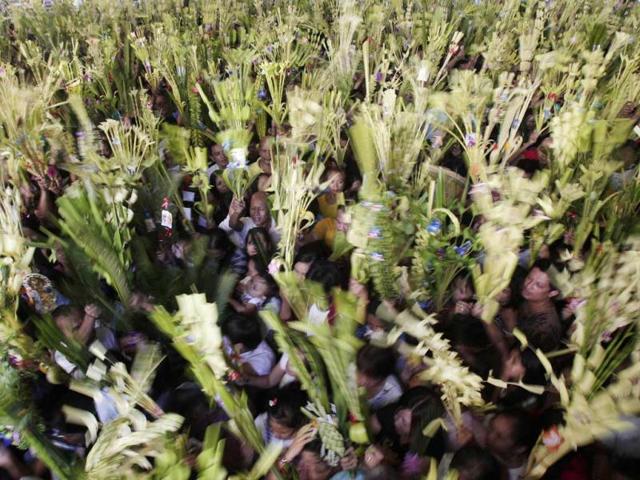 Filipino Catholic devotees wave palm fronds during Palm Sunday rites outside Santo Nino Parish Church in Manila, Philippines. Roman Catholics trooped to churches to commemorate the entry of Jesus Christ into Jerusalem. AP Photo/Aaron Favila