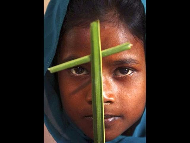 A Catholic tribal girl holds a palm frond as she attends a mass for Palm Sunday at Dantilingi village in Orissa. AP/Biswaranjan Rout
