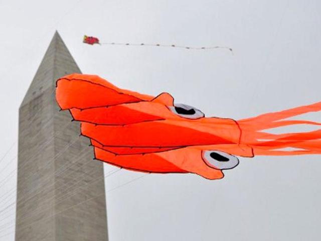 An octopus kite floats past the Washington Monument during the annual Blossom Kite Festival in Wasington, DC. The event is part of the National Cherry Blossom Festival which this year celebrates 100 years of friendship between Japan and the United States. AFP PHOTO Eva Hambach