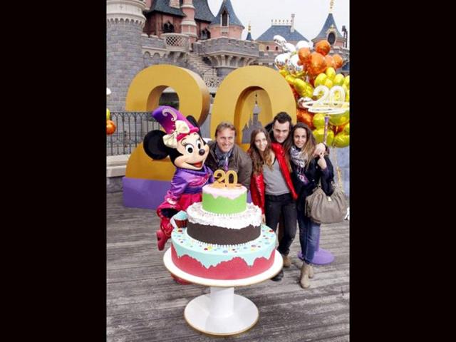 French former international football player David Ginola (2ndL) poses with Disney character Minnie, his wife Coraline (R) and his two children Clara (C) and Andrea (2ndR) during the launch of Disneyland Paris's 20th birthday celebrations at Disneyland Park in Chessy, near Marne-la-Vallee, outside Paris. AFP/Thomas Samson
