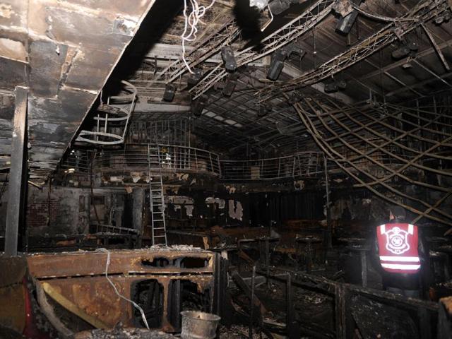 A firefighter inspects the nightclub Contrast in Novi Sad, Serbia. Serbian police say six people died in a nightclub fire in the city in the country's north. (AP Photo)